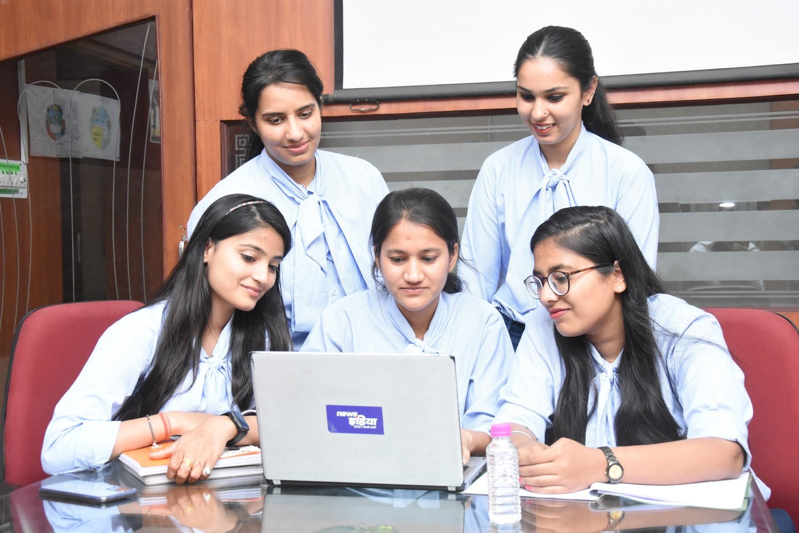Indian students collaborating on a laptop project
